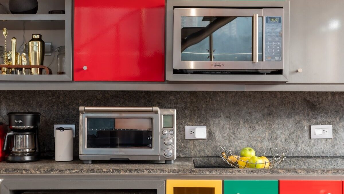 silver microwave oven on black marble counter top