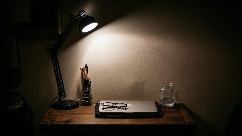 black desk lamp on brown wooden table