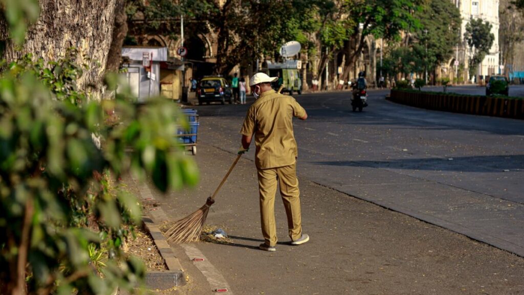 a man with a broom on a street