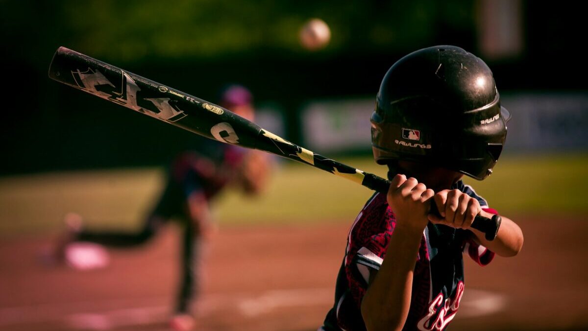 selective focus photography of person holding baseball bat