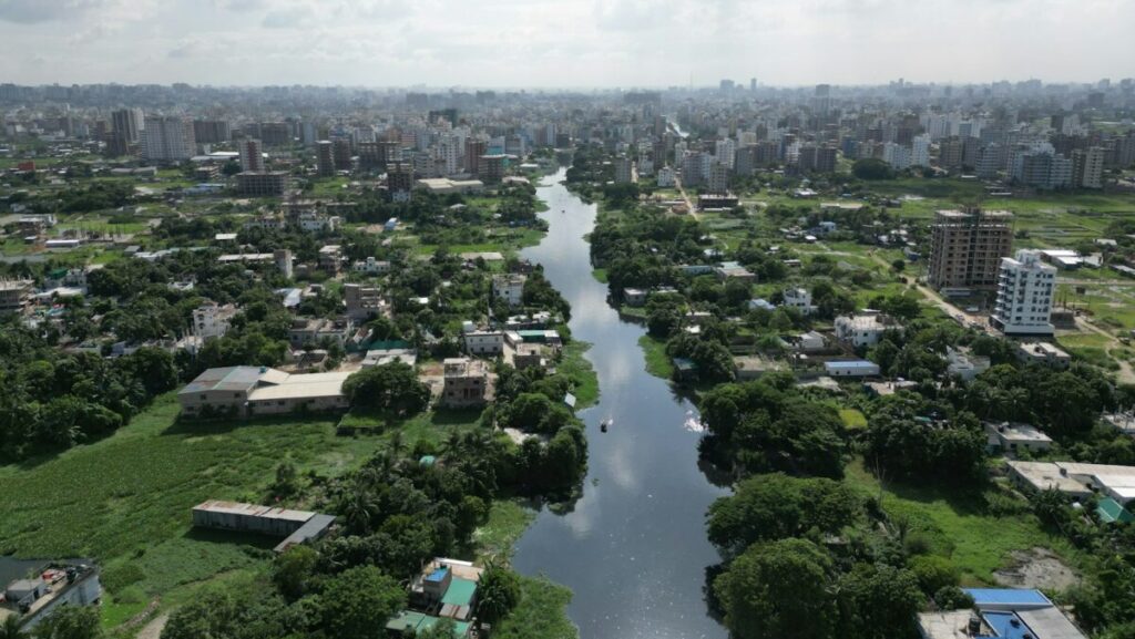 a river running through a lush green countryside