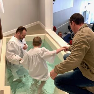 Pastor Rickie Wilson baptizes a child during a recent church service at Hebron Baptist Church in Bush, Louisiana.