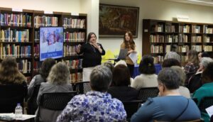 Conference leaders present information during a workshop where people are gathered to attend.