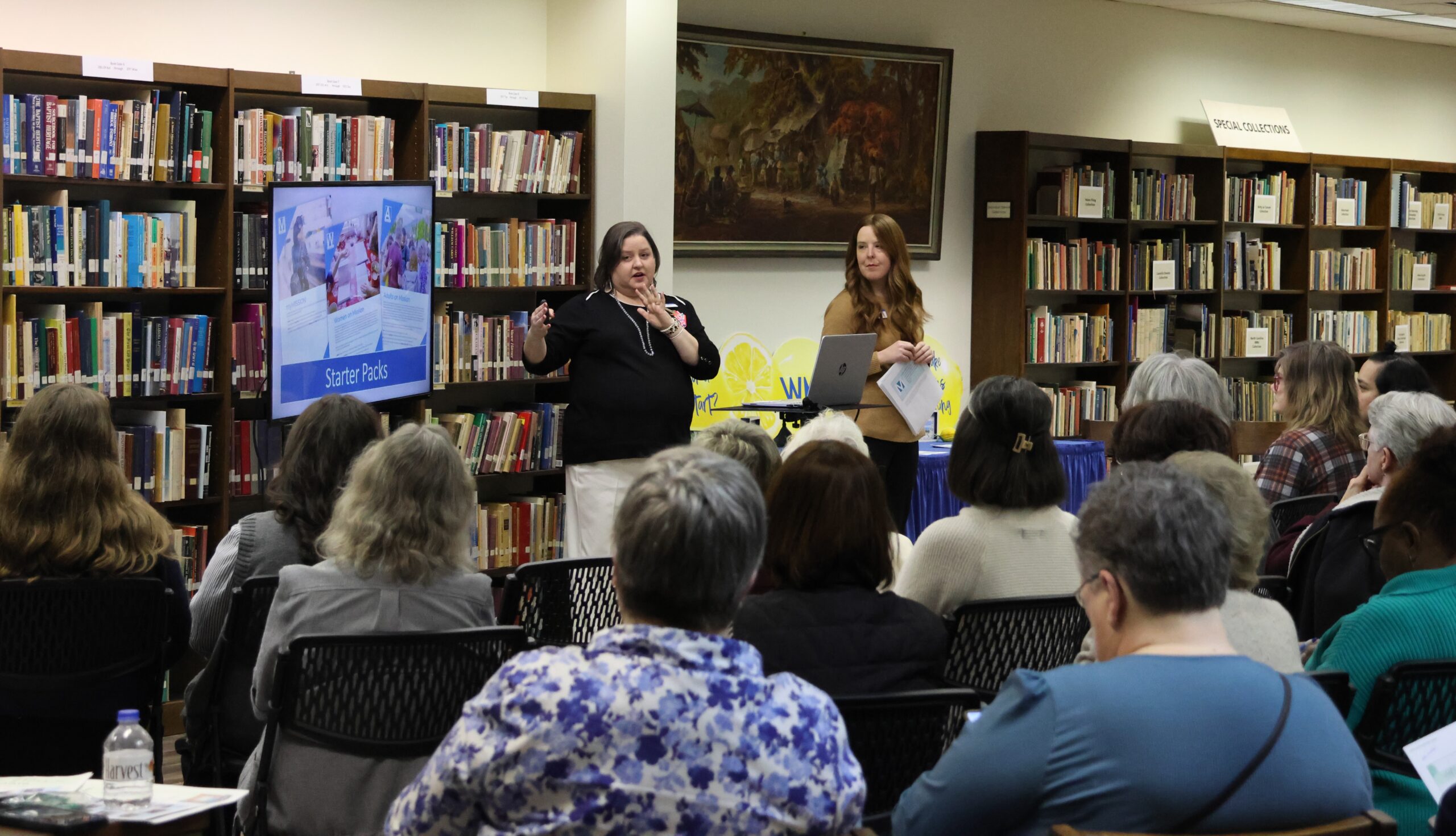 Conference leaders present information during a workshop where people are gathered to attend.