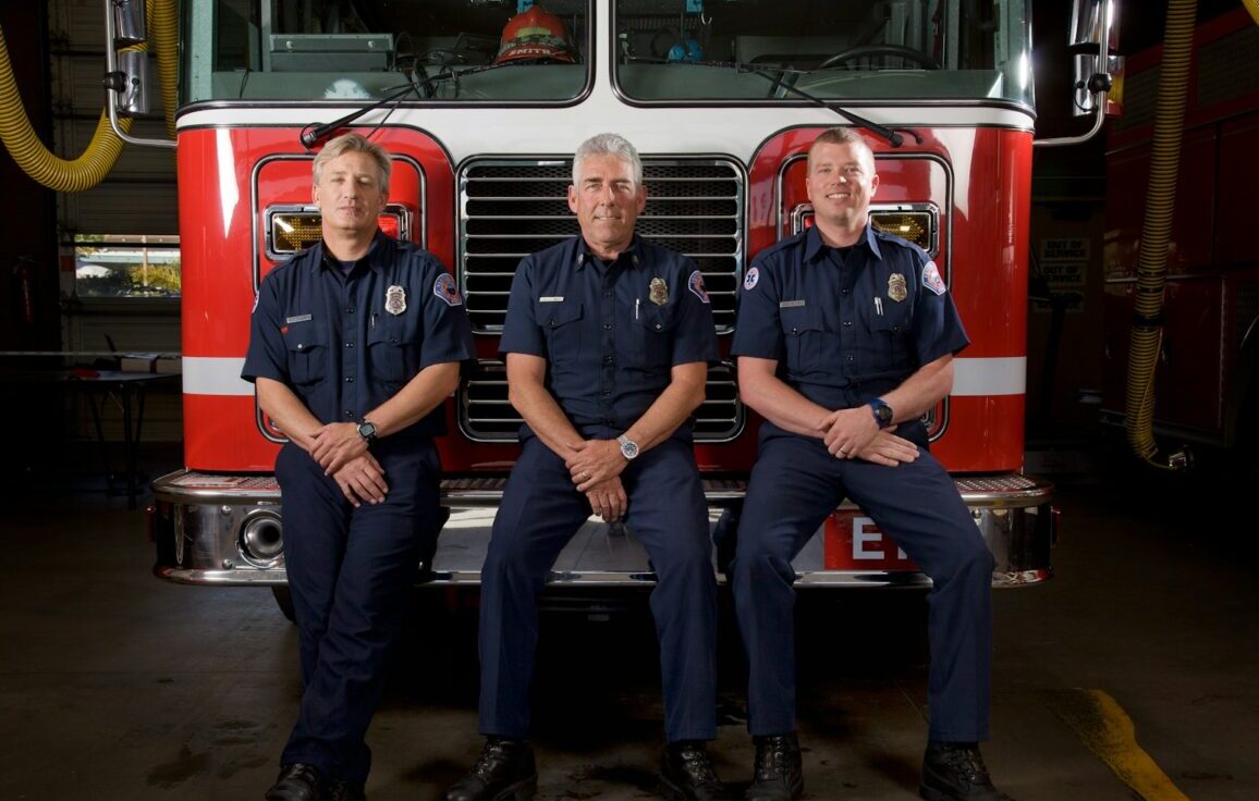 2 men in blue and red polo shirt sitting on red bus