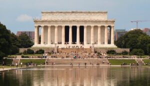 a group of people standing in front of the lincoln memorial