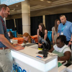 BCM students serve behind scenes in Orlando, set registration records