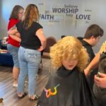 Haircuts, service projects help families prepare to head back to school